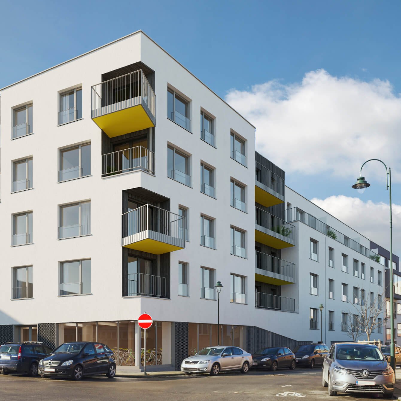 Photo d'un bâtiment neuf dans les ton blanc et jaune